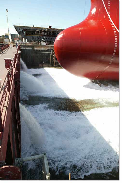 Water from San Diego Bay rushes into NASSCO's graving dock as the float out process for Hull 485, the Alaskan Explorer, begins.
