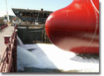 Water from San Diego Bay rushes into NASSCO's graving dock as the float out process for Hull 485, the Alaskan Explorer, begins.