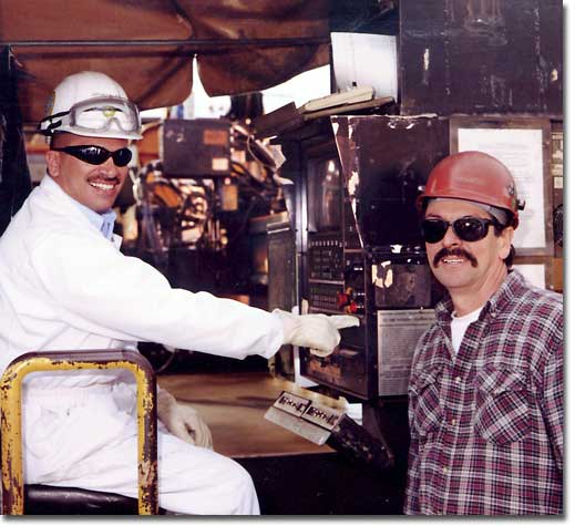 BP Team Member Jeff Gonzales uses a welding machine to cut the first piece of steel for Hull 486, signifying the start of construction on the Alaskan Navigator.  Gonzales is being assisted by NASSCO's Raul Gil.