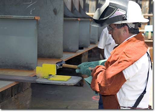 At the keel-laying ceremony for Hull 487, the fourth of the Alaska Class double-hull oil tankers being constructed for BP Oil Shipping Company, BP's Site Team Member John Penso drove in the first wedge and then welded his initials into the keel to signify the start of structural erection.