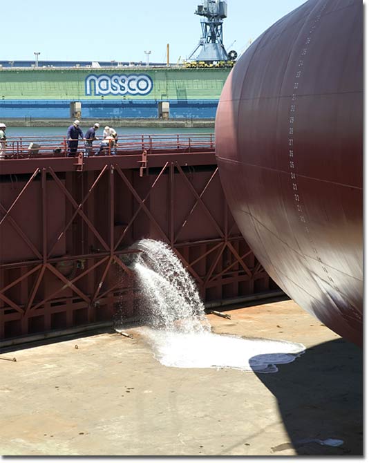 NASSCO personnel begin flooding the graving dock at NASSCO for the float-out of BP-4.