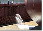 NASSCO personnel begin flooding the graving dock at NASSCO for the float-out of BP-4.