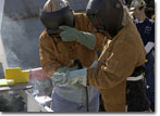 Ms. Patricia Ball, a 26-year NASSCO employee, welds her initials into the keel of the Golden State.