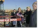 As Juliana Shepard Jenkins looks on, Laura Shepard Churchley breaks the bottle of champagne on the bow of the ship named in honor of their father, Rear Adm. Alan Shepard, the first American into space.&nbsp;