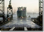 Amid cheers from the crowd and bursting fireworks, the USNS Lewis and Clark slid from the building ways into the waters of San Diego Bay. More than 5,000 people attended the christening and launching ceremony.