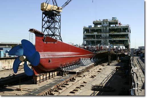 The stern of the T-AKE 1, to be named the Lewis and Clark, begins to take shape on NASSCO's building ways.  The ship's power train will feature twin synchronous Alstom propulsion motors driving a single fixed-pitch propeller, and will achieve a speed of 20 knots at design draft and 80% propulsion.