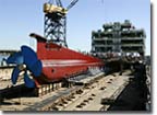 The stern of the T-AKE 1, to be named the Lewis and Clark, begins to take shape on NASSCO's building ways.  The ship's power train will feature twin synchronous Alstom propulsion motors driving a single fixed-pitch propeller, and will achieve a speed of 20 knots at design draft and 80% propulsion.