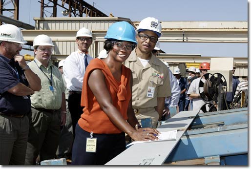 On September 15, 2004, DeAnne Sutton, wife of Commander George Sutton (R) of the NAVSEA Program Office, completed the first cut and signed off on the first steel piece for the second T-AKE ship, to be named the USNS Sacagawea.