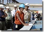 On September 15, 2004, DeAnne Sutton, wife of Commander George Sutton (R) of the NAVSEA Program Office, completed the first cut and signed off on the first steel piece for the second T-AKE ship, to be named the USNS Sacagawea.