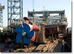 A stern view of T-AKE 2, as she sits on the building ways at General Dynamics NASSCO in the fall of 2005