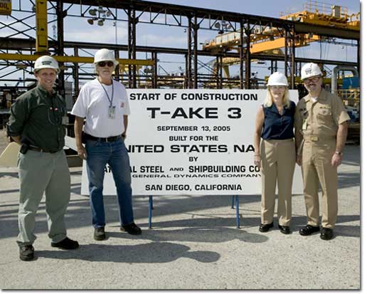 Graham Dodd, NASSCO's Director of Steel, and Mike Trimble, Military Sealift Command (MSC) Ship's Project Manager, pose with Navy Captain Mike Stanton, Commanding Officer, Supervisor of Shipbuilding, and Mrs. Jennifer Stanton, who made the first cut on the ship's first steel plate to signify the start of construction of the T-AKE 3.