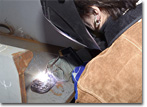General Dynamics Senior Vice President Phebe Novakovic welds her initials into the T-AKE 5 keel plate. 