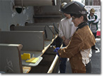 The first wedge is driven into the ship to join two keel blocks.