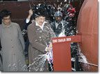 Dr. Drew's eldest daugher, Mrs. Bebe Drew Price, breaks a champagne bottle against the USNS Charles Drew on christening day.