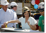 Mrs. Serpa measures the first metal part cut for T-AKE 10.