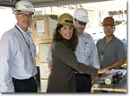 Mrs. Rosie Eckberg, wife of NASSCO's Government Ship Program Manager Steve Eckberg, initiates the first automated cut of steel for T-AKE 12 .