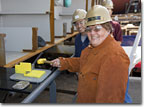 Mrs. Landay prepares to drive the fit-up wedge for the T-AKE 12 keel.