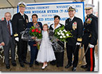 Flower girl Tara Mooney presents her flowers to Sponsor Myrlie Evers and Matron Reena Evers-Everette of the christening party for the USNS Medgar Evers on November 12, 2011.