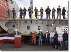 Brian Ruiz introduces Mrs. Buzby at the ceremony, with members of the construction crew observing.