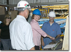 Mrs. Mary Knierim starts the robotic steel cutter to begin T-AKE 5's construction.