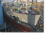 The 500-ton bow section of T-AKE 6 is lifted into place on October 25, 2007.