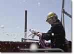 Ship Sponsor Mrs. Amy Kleppner christens her aunt's namesake ship with champagne.
