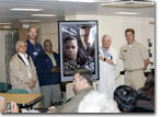 NASSCO production managers present a commemorative Men of Honor movie poster to the ship's captain at the March 4 delivery.