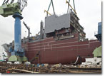 An accommodation block is lifted onto T-AKE 7 in early April 2008.