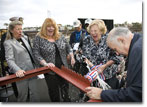 Ship's Sponsor Mrs. Wally Schirra breaks the christening champagne bottle at the launch of T-AKE 8.