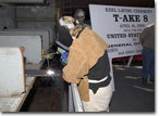 Mrs. Hannah Goddard, wife of PEO Ships RADM Chuck Goddard, welds her initials into the keel of T-AKE 8 on April 14, 2008.