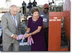 Ship Sponsor Hester Evans breaks the ceremonial champagne bottle against her great-great-great-grandfather's namesake ship.