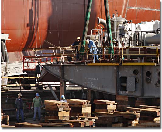 NASSCO employees lay a keel block for T-AKE 9 on the building ways in October 2008.