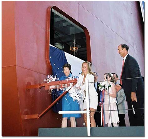 Ship's sponsors Lynn Garvey, wife of Mike Garvey, Chairman of the Board of TOTEs parent company Saltchuk Resources, Inc., and Lily Stevens, the daughter of Senator Ted Stevens (R- Alaska),&nbsp;christen the M. V. Midnight Sun with ceremonial bottles of champagne as NASSCO President Richard Vortmann looks on.