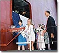 Ship's sponsors Lynn Garvey, wife of Mike Garvey, Chairman of the Board of TOTEs parent company Saltchuk Resources, Inc., and Lily Stevens, the daughter of Senator Ted Stevens (R- Alaska),&nbsp;christen the M. V. Midnight Sun with ceremonial bottles of champagne as NASSCO President Richard Vortmann looks on.