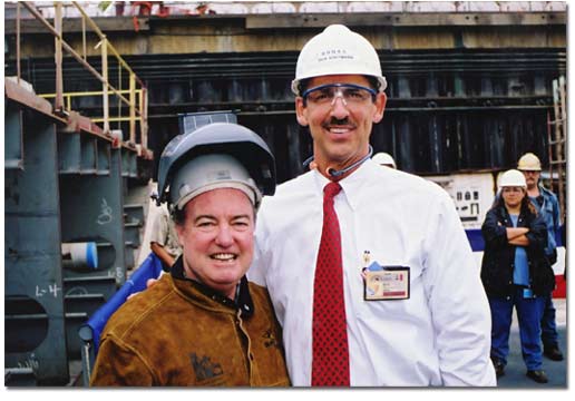 Robert P. Magee (L), President and Chief Executive Officer of TOTE, and Richard Vortmann, President of NASSCO, pose at the October 2001 keel-laying ceremony for the M. V. Midnight Sun, the first of two ORCA-class roll-on/roll-off trailerships being built for TOTE's Tacoma-to-Anchorage service. McGee drove in a wedge that signified the fit-up of the first keel blocks and then welded his initials onto a steel plate that will become a permanent part of the ship.