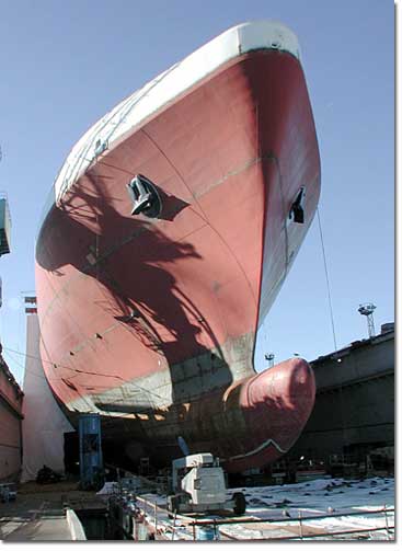 The hull of the ship is completed and readied for painting. The bulbous bow design decreases horsepower requirements and fuel consumption, making the ship more energy efficient.